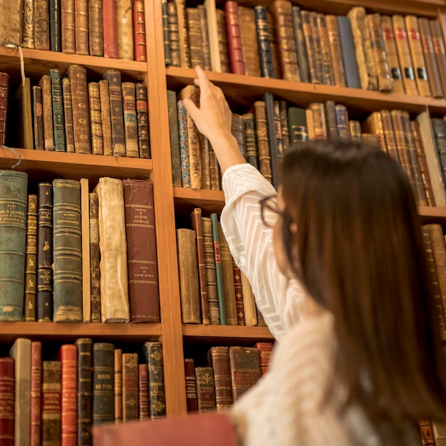 Girl chooses a book in the library