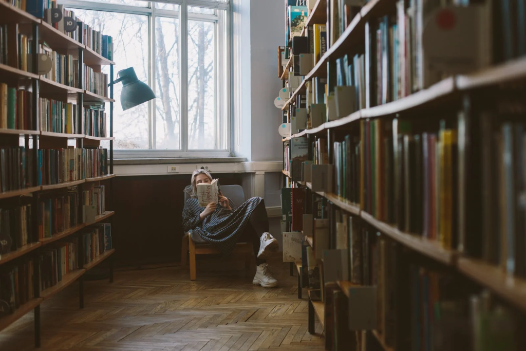 Girl reading a book in the library