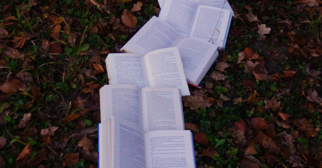 Open books lie in the leaves