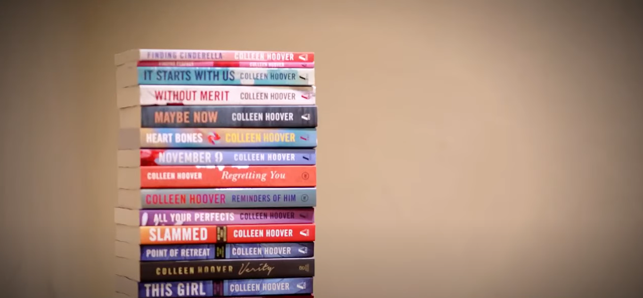 A stack of diverse books authored by Colleen Hoover