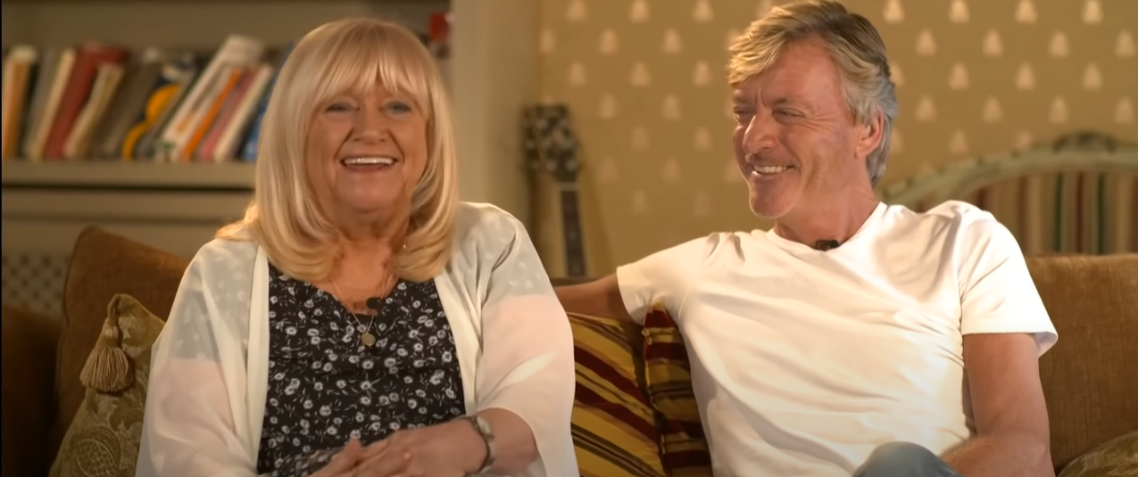Richard Madeley and Judy Finnigan sitting on a couch